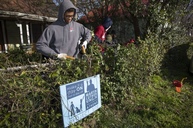 Martin Luther King Jr. (MLK) Day of Service Students volunteers manicuring a yard